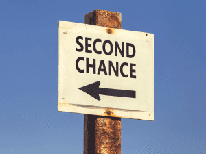 Image of a sign reading 'Second Chance' with an arrow pointing forward, symbolizing a new opportunity or direction.